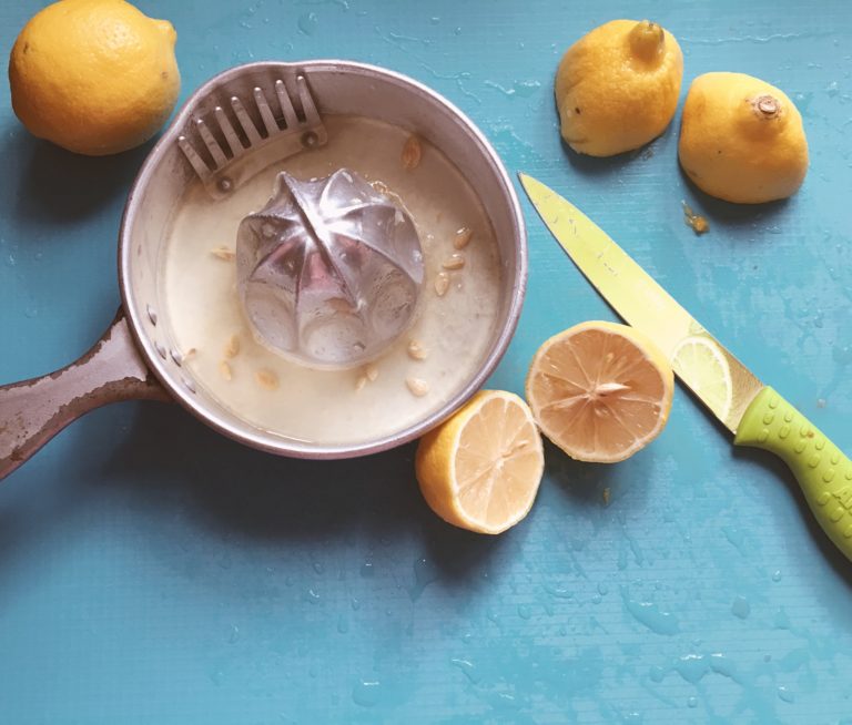 squeezing lemons with old lemon juicer