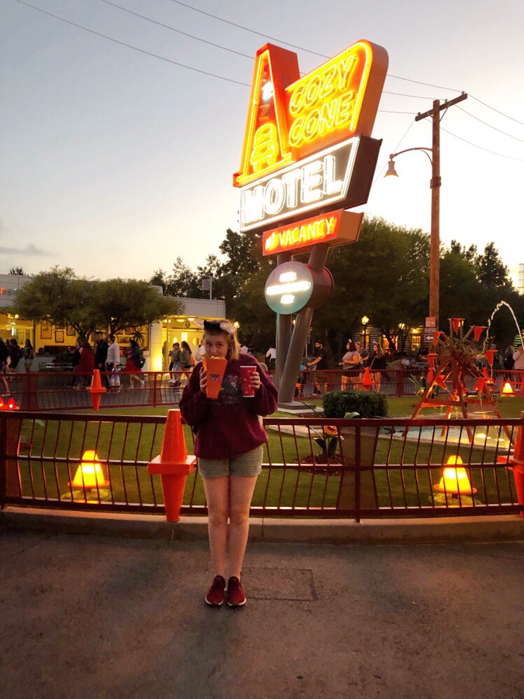 Hannah enjoying her popcorn in front of the Cozy Cone Motel sign- Cars Land, Disney's California Adventure